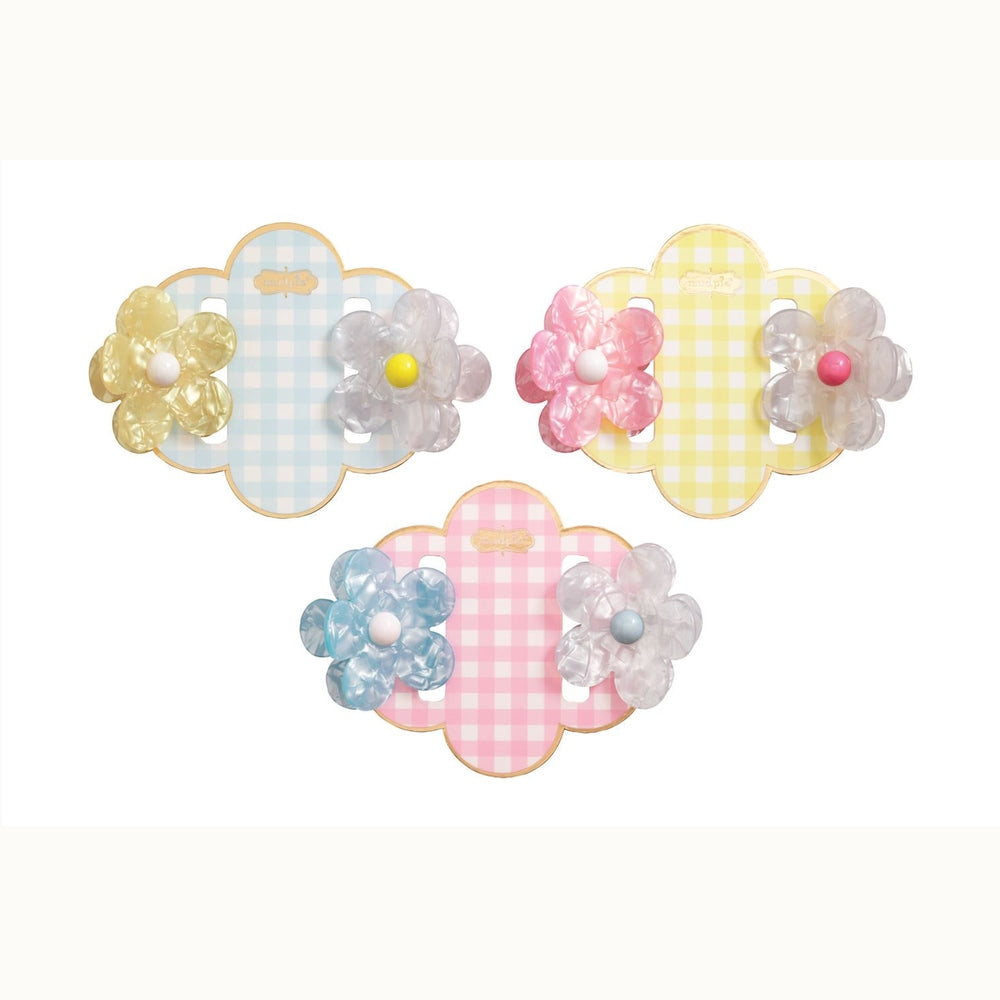 Pearlescent acrylic flower hair clips by Mud Pie displayed on blue yellow and pink gingham scalloped cards featuring colorful bead centers and marble textures against a white background