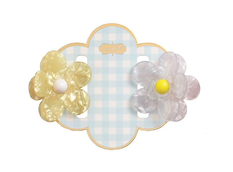 Resin hair clips by Mud Pie featuring a marbled yellow flower and an iridescent clear flower with bright centers on a light blue gingham scalloped display card