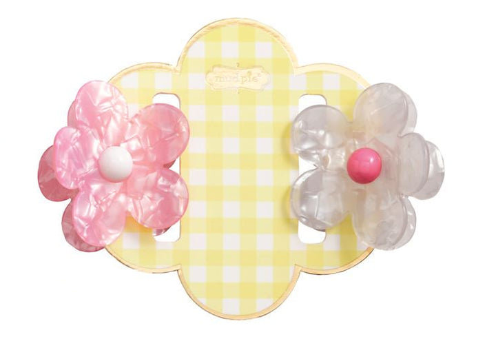 Marbled acrylic hair clips by Mud Pie featuring one pink and one translucent white flower accessory with contrasting colorful centers on a yellow and white gingham checkered scalloped display card