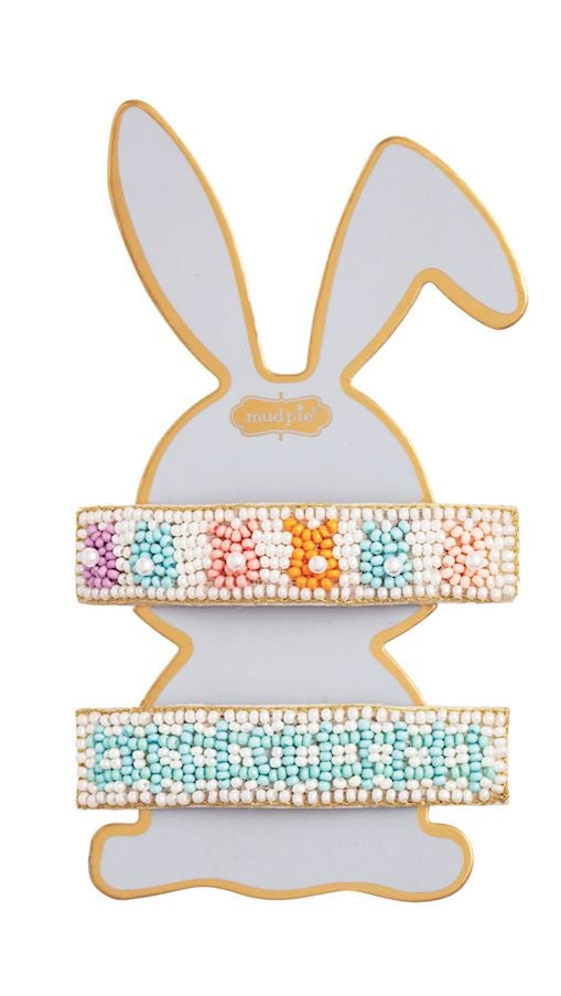 Hand-beaded barrettes by Mud Pie featuring two decorative hair clips displayed on a bunny-shaped card highlighting colorful pastel beaded rabbits with pearl tails and a turquoise geometric pattern