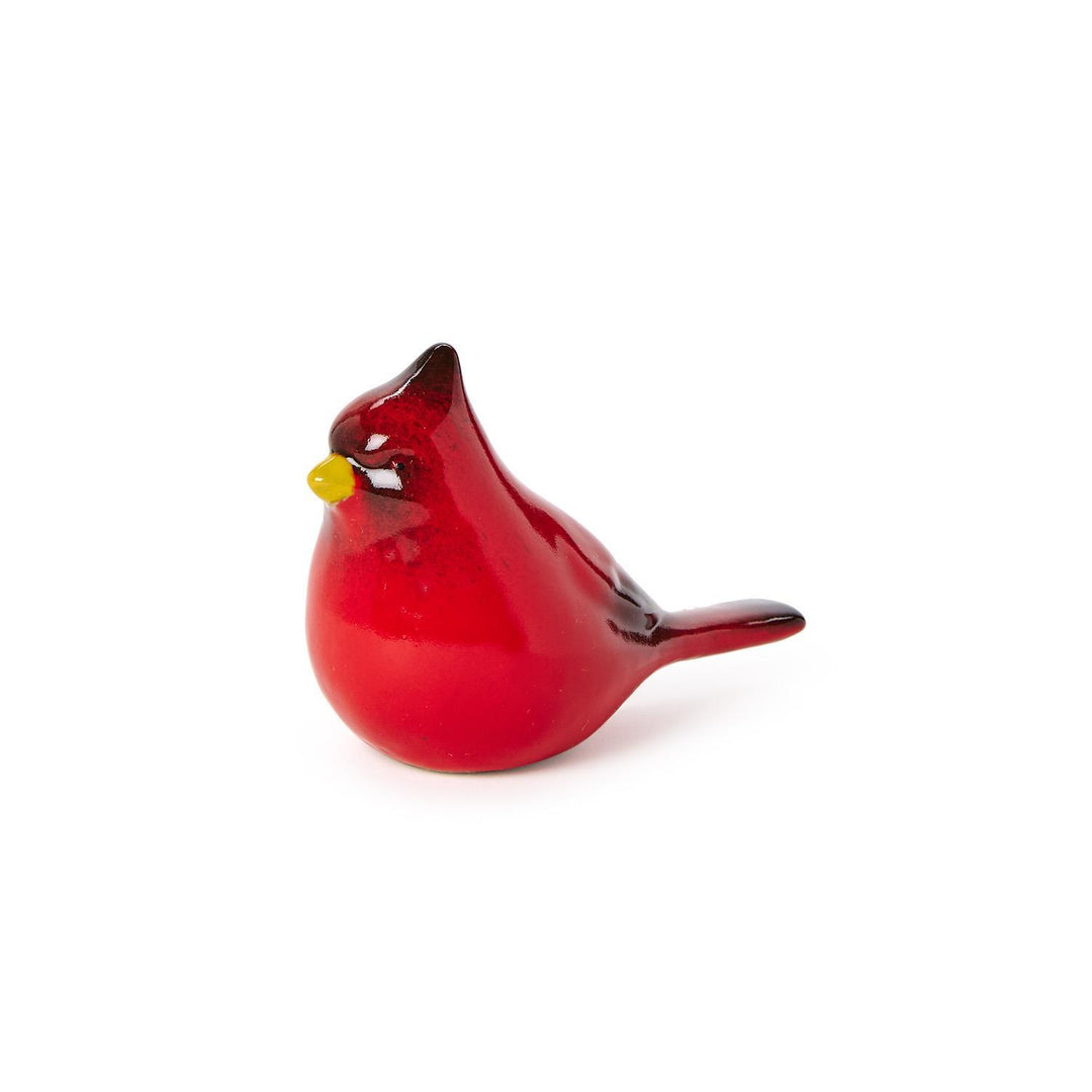 Handcrafted glass figurine of a northern cardinal bird on a white background featuring a glossy red body, a pointed crest, and a bright yellow beak with a dark facial mask