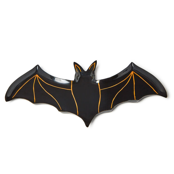 Ceramic bat-shaped Halloween serving platter featuring a glossy black glaze with thin orange hand-painted outlines highlighting the ears and wing structure centered against a white background