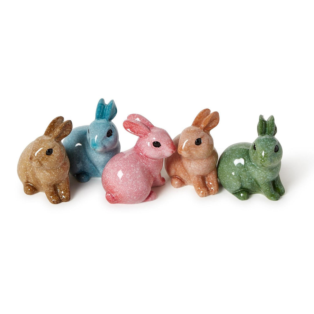 Glazed ceramic figurines of five small bunnies on a white background featuring a unique mottled glaze and vibrant shades of pink, turquoise, and lime green