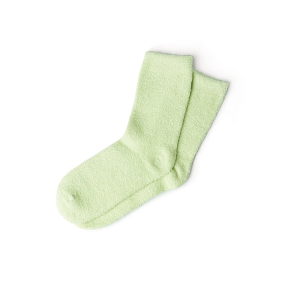 Studio photograph of a pair of mint green fuzzy socks on a white background featuring a soft chenille texture and a cozy crew-length silhouette