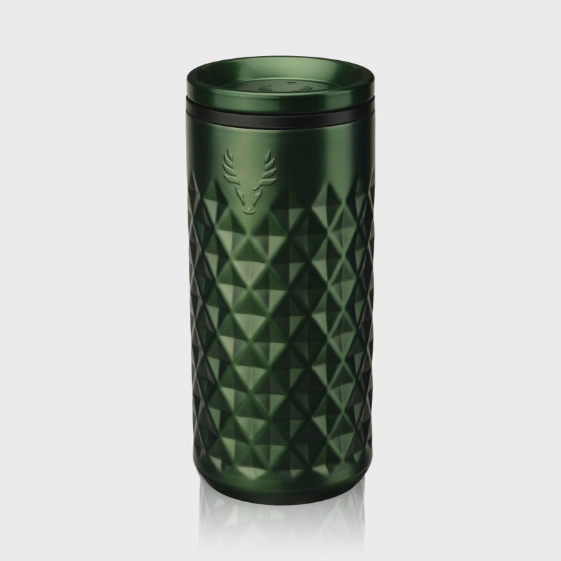Stainless steel Jägermeister travel tumbler, a dark green metallic mug on a reflective gray background featuring an iconic debossed stag logo and a three-dimensional diamond geometric texture