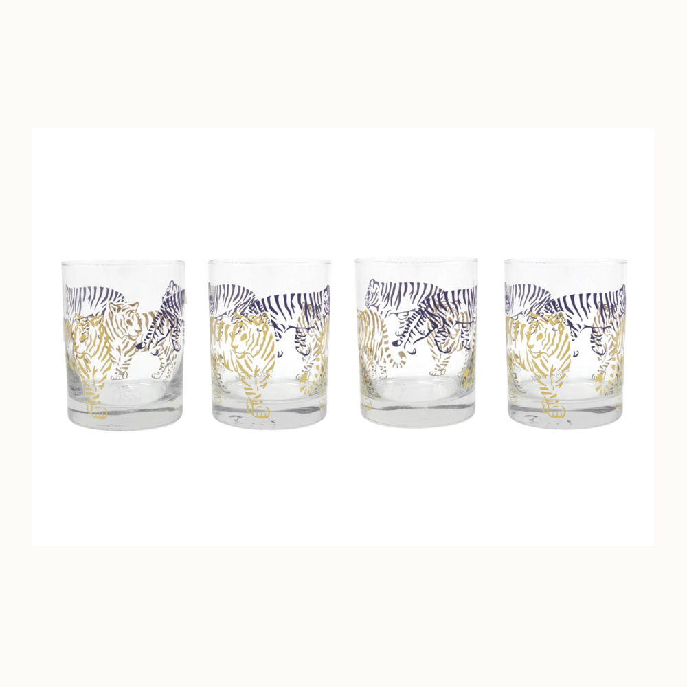 Set of four screen-printed glass tumblers featuring prowling tiger illustrations in metallic gold and navy blue stripes against a plain white background
