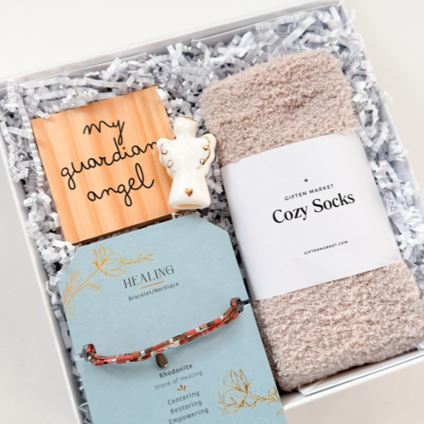 Gift set with 'My Guardian Angel' book, bracelet, and cozy socks in a box.