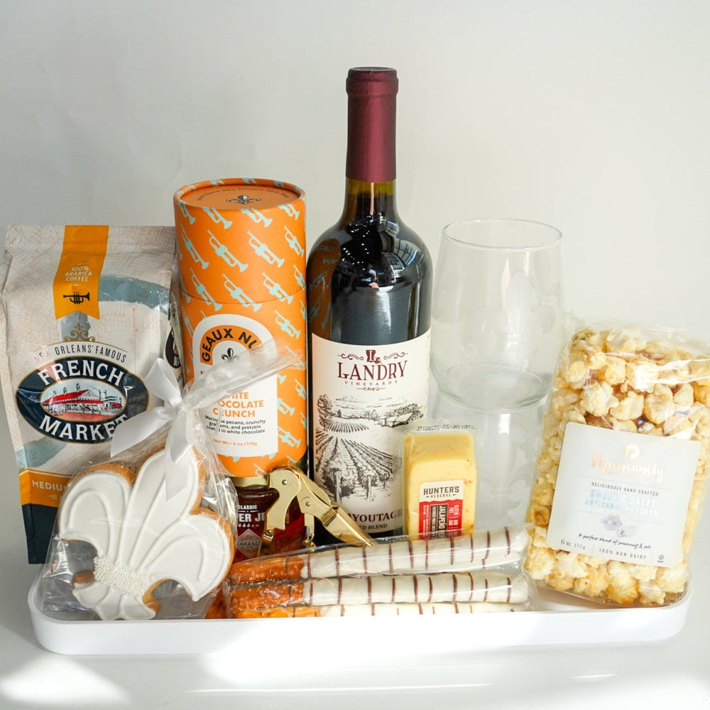 Tray with wine, popcorn, and snacks on a white background