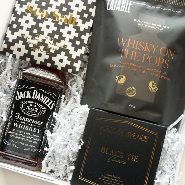 Photograph of a luxury curated gift box featuring an iconic bottle of Jack Daniel&