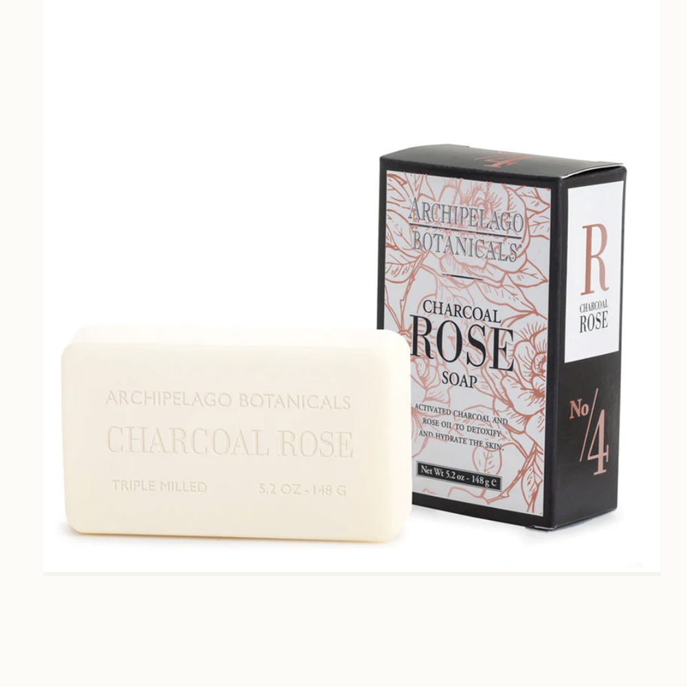 Product photograph of Archipelago Botanicals Charcoal Rose Soap featuring a debossed cream-colored bar beside its black packaging adorned with peach-toned rose illustrations and a prominent copper No 4 logo