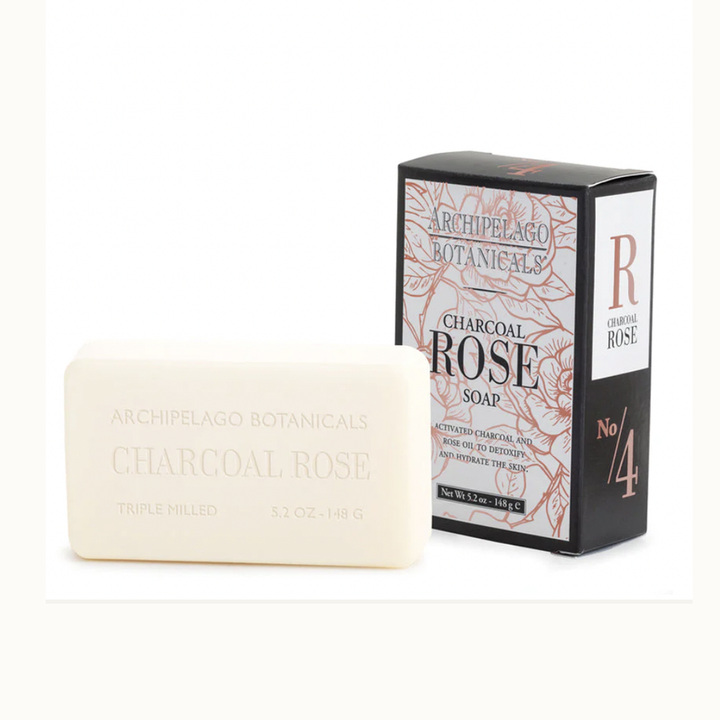 Product photograph of Archipelago Botanicals Charcoal Rose Soap featuring a debossed cream-colored bar beside its black packaging adorned with peach-toned rose illustrations and a prominent copper No 4 logo