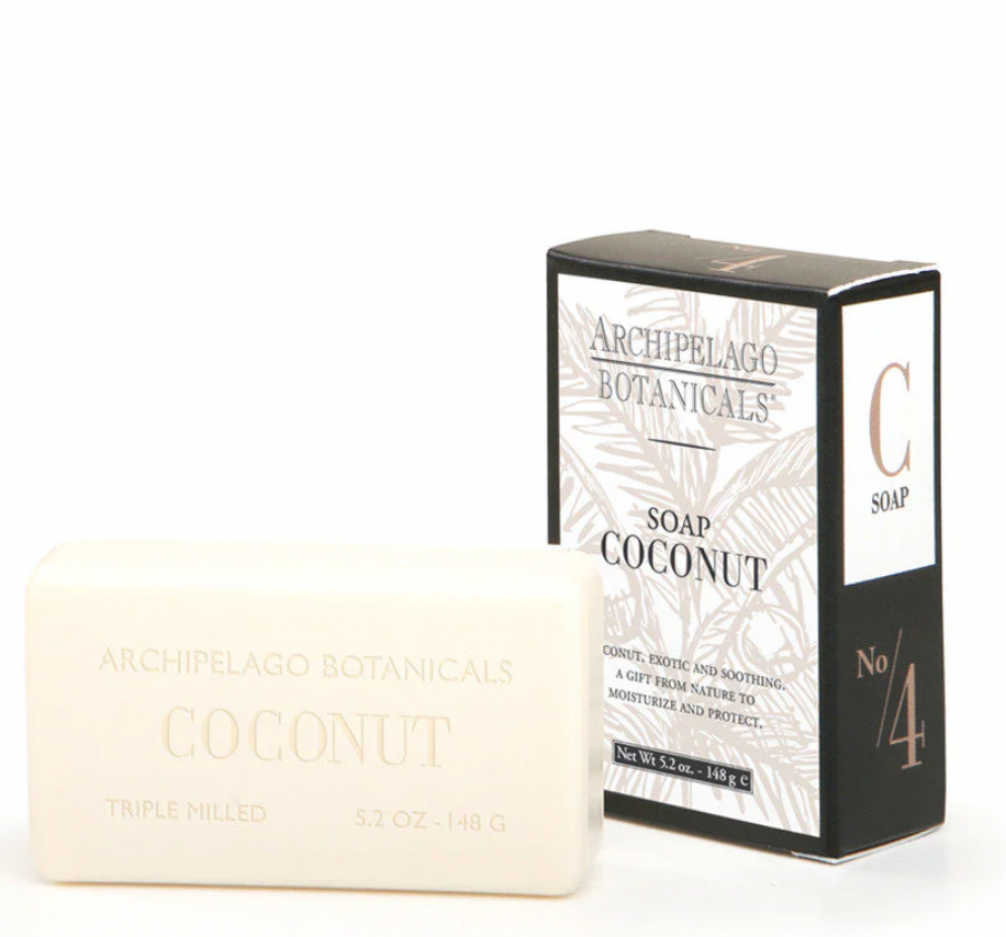 Product photograph of Archipelago Botanicals Coconut bar soap and packaging on a white background featuring a creamy triple milled bar, a black box with copper-toned numbering, and an elegant palm leaf pattern