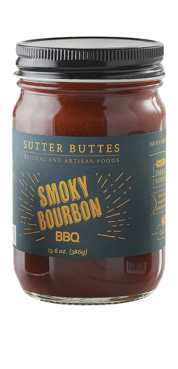 Studio photograph of Sutter Buttes Smoky Bourbon BBQ sauce in a glass jar featuring a dark teal label with gold-toned lettering and a ribbed black metal lid against a white background