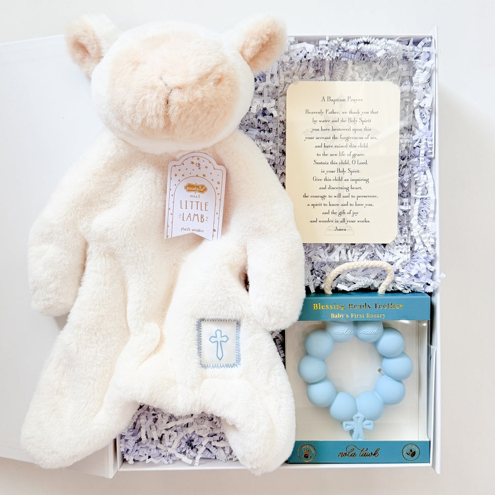 Baby gift set with white teddy bear, teething ring, and card on a white background