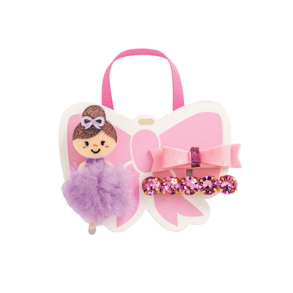 Product photography of a Super Smalls hair accessory set featuring a ballerina doll clip with a purple tulle tutu, a glossy pink bow, and a row of fuchsia gems on a butterfly-shaped display card