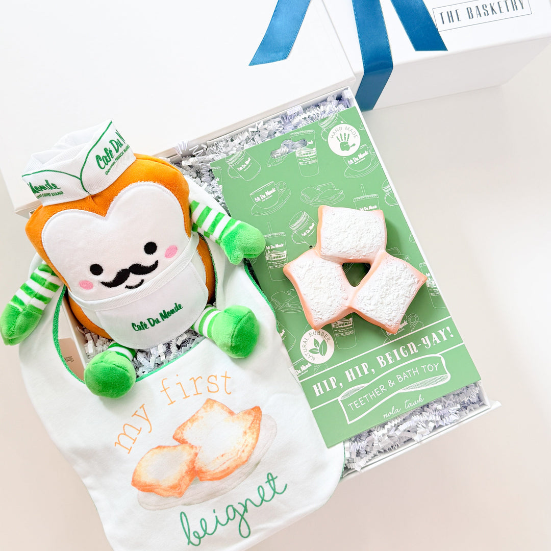 Gift set with a plush toy, cookies, and a card on a white background