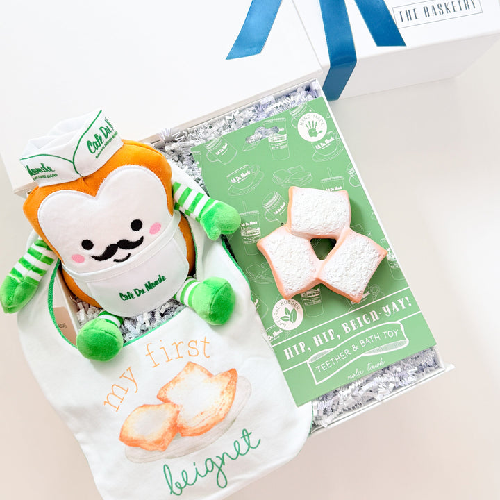 Gift set with a plush toy, cookies, and a card on a white background