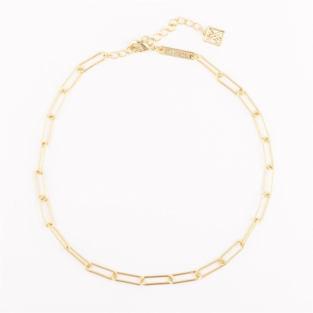Gold paperclip link necklace by Ciccarelli displayed on a white background featuring high-polish elongated rectangular links, a signature square geometric logo charm, and a lobster claw clasp with an adjustable extender chain