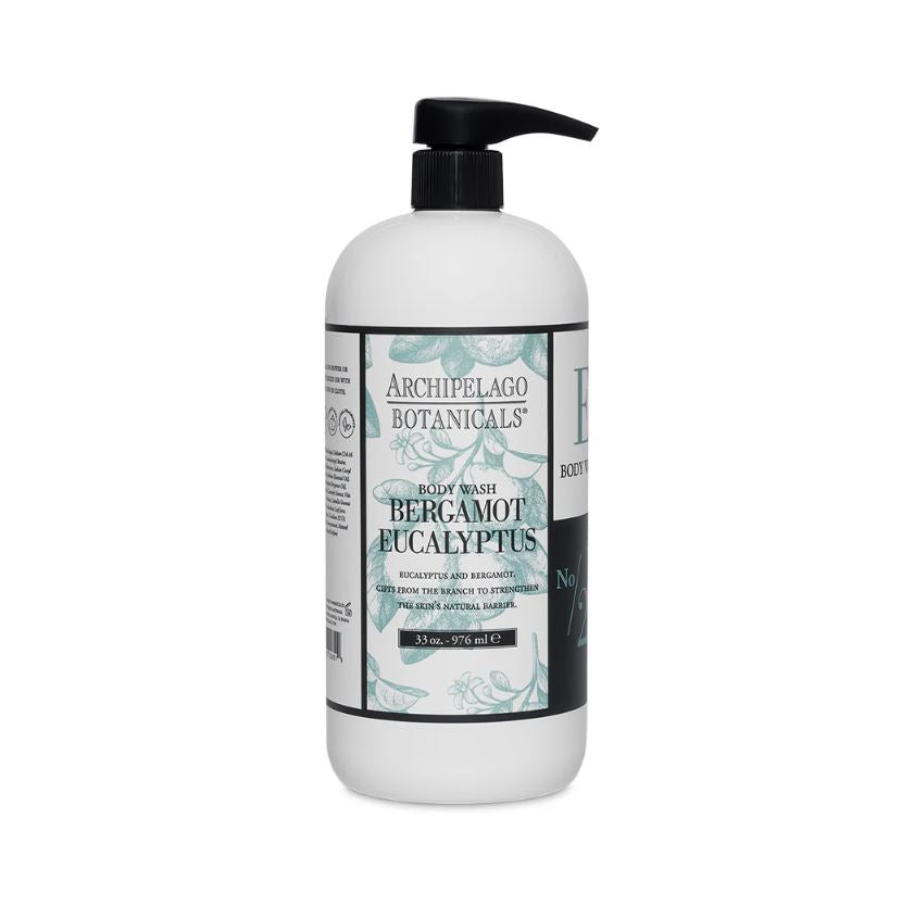 Product photography by Archipelago Botanicals of a Bergamot Eucalyptus body wash bottle on a white background featuring a black pump dispenser and intricate teal botanical illustrations of citrus and leaves