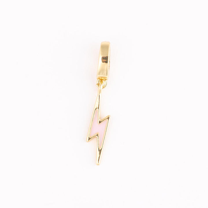 Gold and enamel jewelry charm of a pink lightning bolt on a white background featuring a soft enamel fill, polished gold-tone metallic edges, and a simple circular bail