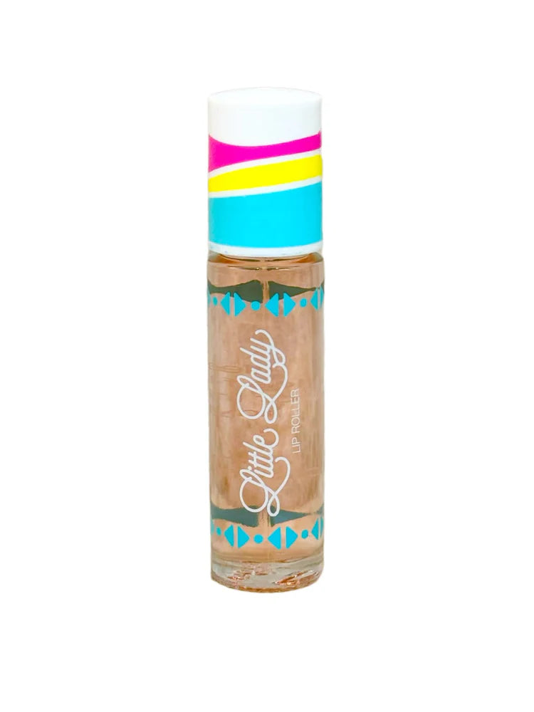 Product photograph by Little Lady of a lip roller on a white background featuring a cap with vibrant pink, yellow, and blue stripes, teal geometric motifs, and white cursive branding over a peach-colored liquid