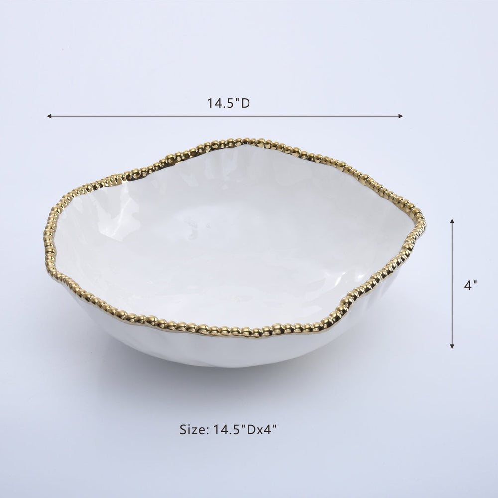 Ceramic glossy white decorative bowl in a studio setting featuring an organic irregular wavy edge and a textured metallic gold beaded rim