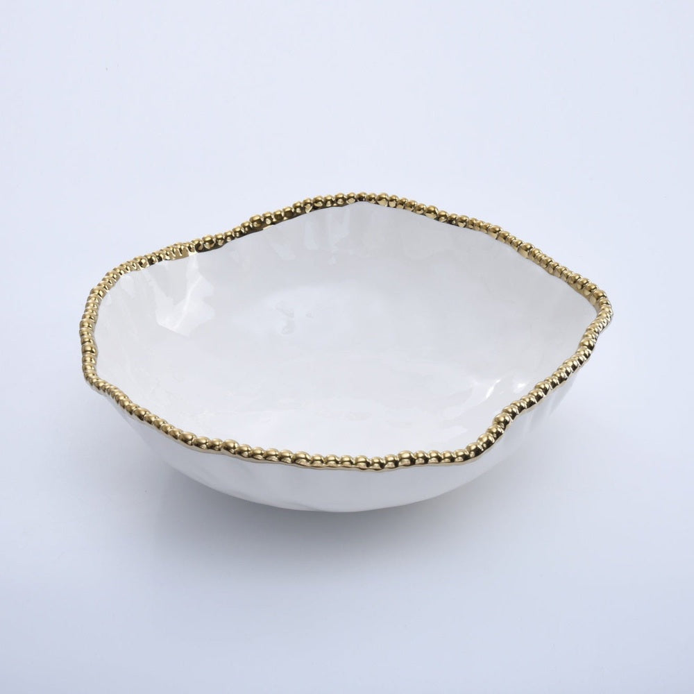 Ceramic white decorative bowl with an organic wavy rim and a metallic gold beaded edge positioned on a plain neutral surface