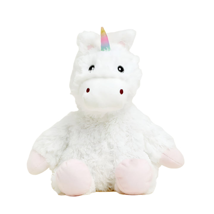 A studio photograph of a fluffy white unicorn plush toy sitting against a plain white background featuring a shimmering rainbow-colored horn, light pink hooves, and small red nostrils