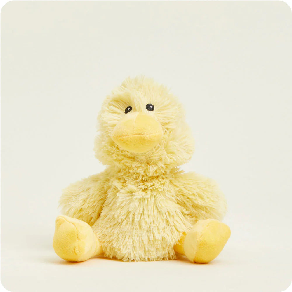 Plush toy by Jellycat of a yellow duckling centered on a white background featuring shaggy textured fur, small black bead eyes, and a smooth yellow beak