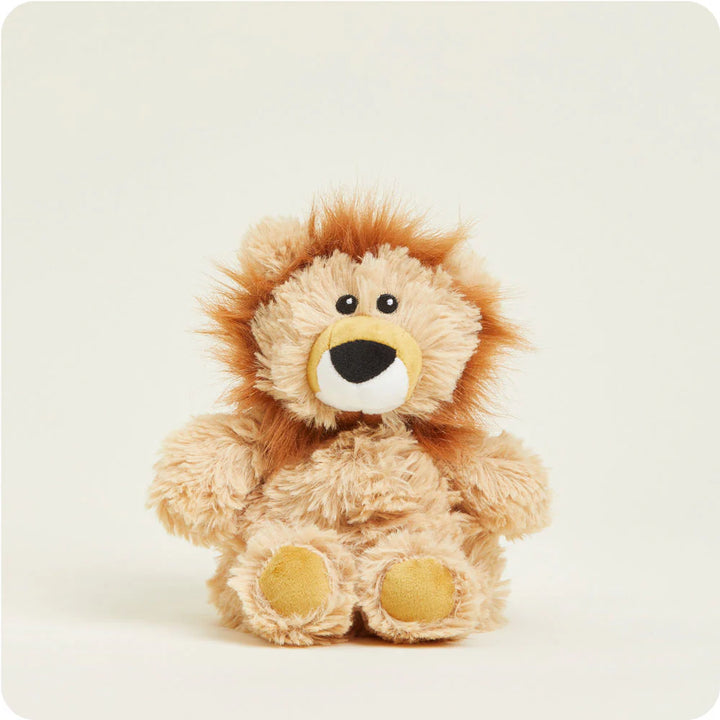 Photograph of a Jellycat plush lion toy centered against a clean white backdrop featuring a shaggy orange mane, small black bead eyes, and soft yellow paw pads