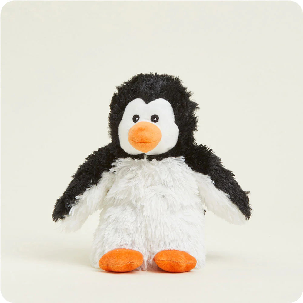 Plush toy by Jellycat of a Peanut Penguin standing on a neutral studio background featuring shaggy black and white fur, small black eyes, and vibrant orange feet