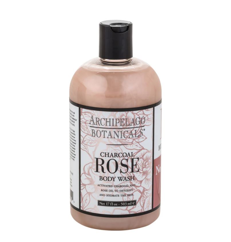 Product photograph by Archipelago Botanicals showcasing a bottle of Charcoal Rose Body Wash filled with dusty pink liquid and featuring a black flip-top cap and a pink floral-illustrated label against a white background