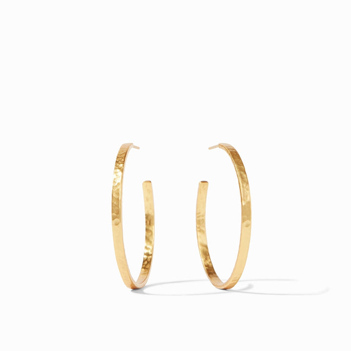 Julie Vos hammered 24K gold-plated hoop earrings featuring a hand-hammered texture and a reflective metallic finish centered on a minimalist white background