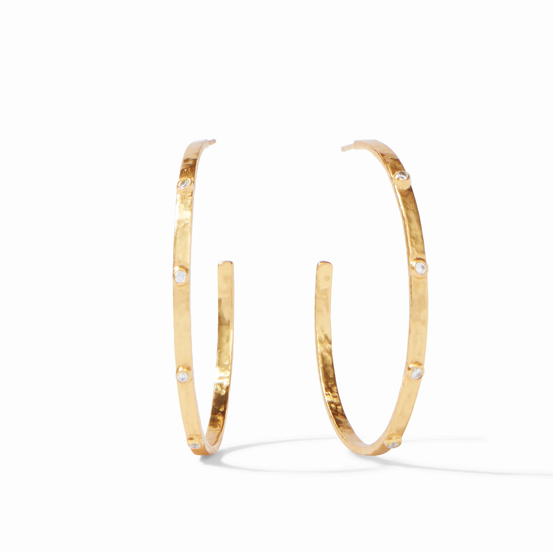 24k gold plate jewelry by Julie Vos featuring a pair of hoop earrings on a white background with a hand-hammered texture and sparkling inset clear crystals