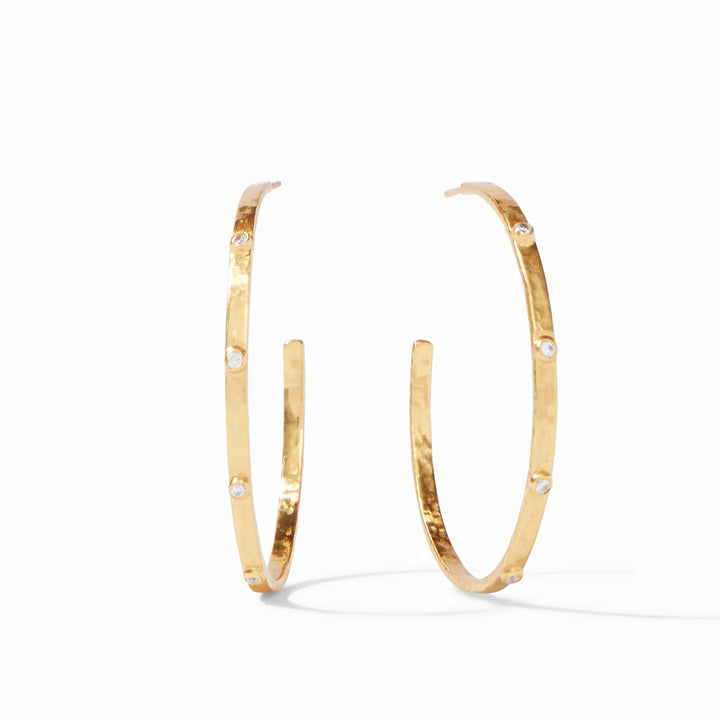 24k gold plate jewelry by Julie Vos featuring a pair of hoop earrings on a white background with a hand-hammered texture and sparkling inset clear crystals
