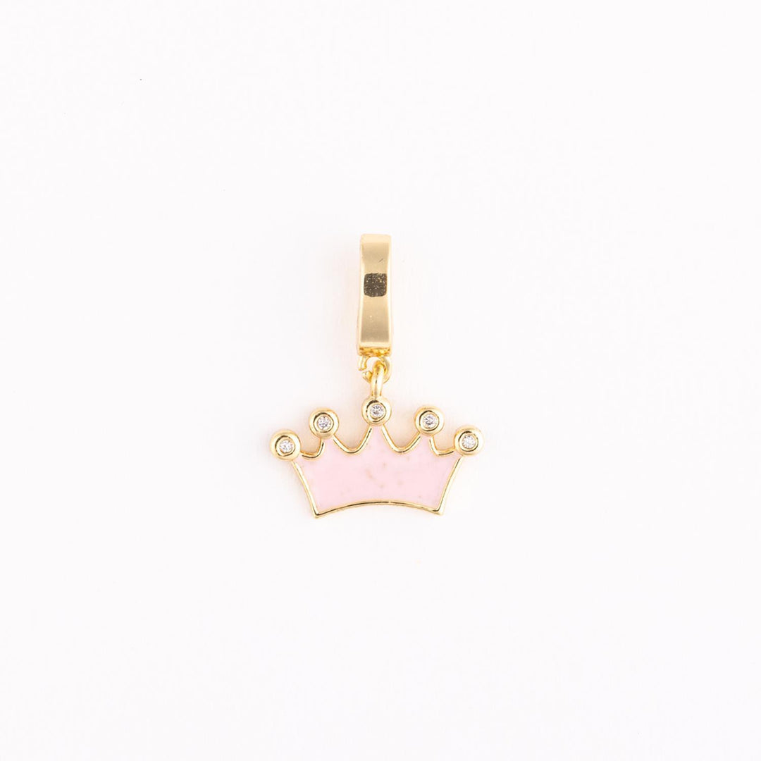 Gold and pink enamel charm featuring a five-pointed crown jewelry pendant centered on a white background with shimmering clear crystals at each peak and a polished yellow gold bail