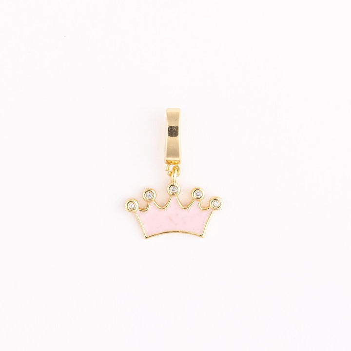Gold and pink enamel charm featuring a five-pointed crown jewelry pendant centered on a white background with shimmering clear crystals at each peak and a polished yellow gold bail