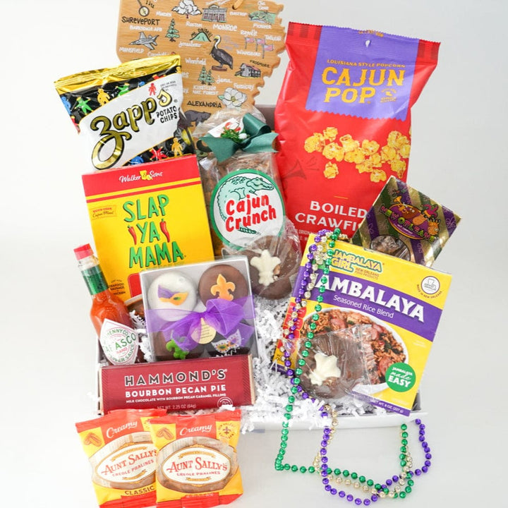 Digital photograph of a Louisiana-themed gift basket featuring regional favorites like Zapp’s chips and Tabasco sauce decorated with colorful Mardi Gras beads and a wooden state map ornament depicting local icons and city names