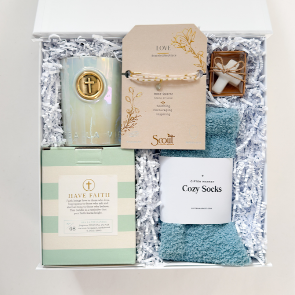 Gift set with candles, cards, and socks in a box