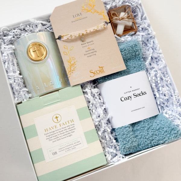 Gift set with candle, card, and socks in a box