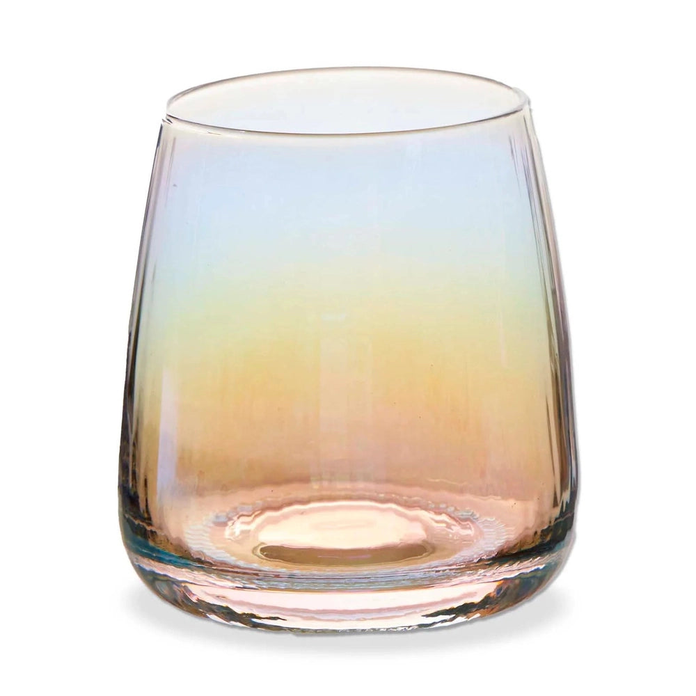 Iridescent glass tumbler on a plain white background featuring a vibrant sunset-inspired gradient of blue, yellow, and peach tones with a tapered rim and thick weighted base