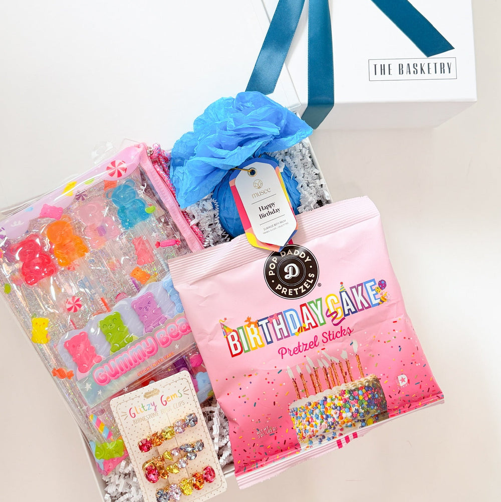 Packaged items with a blue bow on a white surface