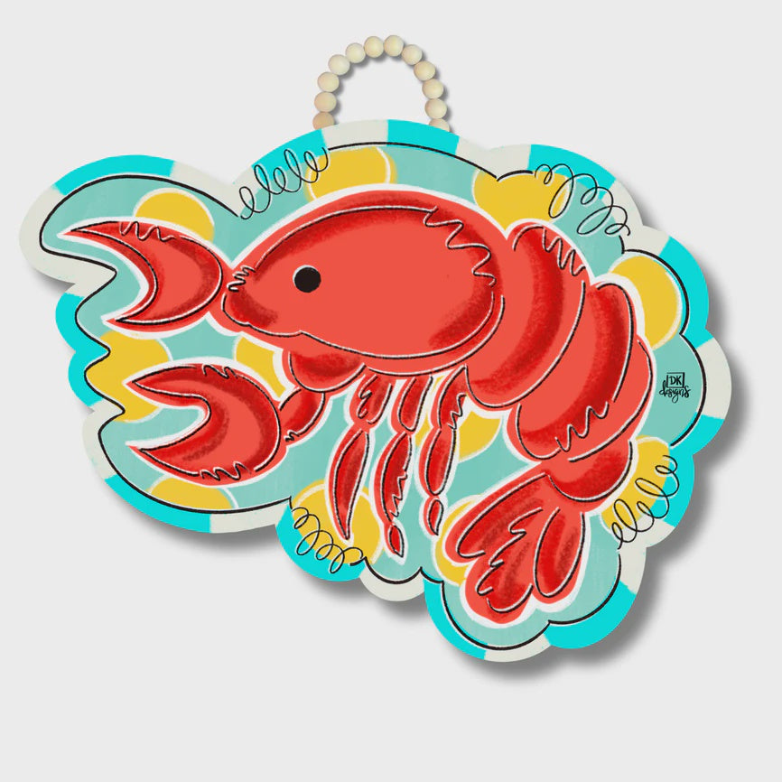 Illustrated wooden door hanger by DK Designs featuring a bright red lobster set against a vibrant teal and yellow scalloped background with a beaded wooden handle and whimsical black swirls