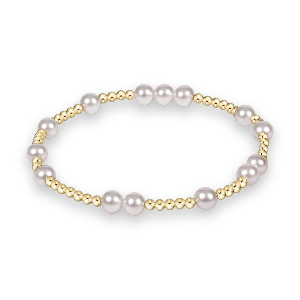 Jewelry art by an unidentified artist of a gold and pearl beaded bracelet centered on a white background featuring lustrous white pearls and clusters of small polished yellow gold spherical beads in a repeating circular pattern