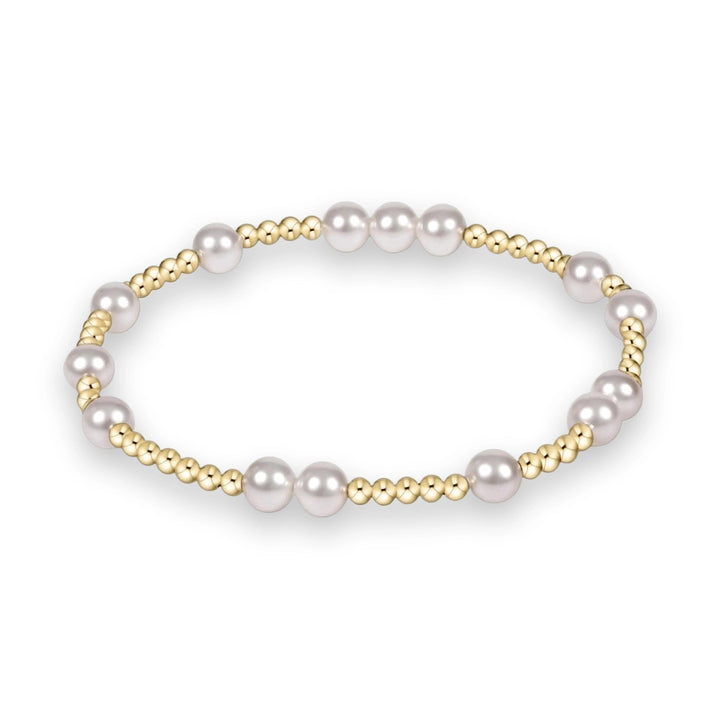 Jewelry art by an unidentified artist of a gold and pearl beaded bracelet centered on a white background featuring lustrous white pearls and clusters of small polished yellow gold spherical beads in a repeating circular pattern