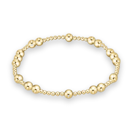 Gold beaded bracelet featuring a symmetrical arrangement of polished spherical beads in varying sizes with a high-shine reflective finish and a smooth metallic luster set against a clean white background