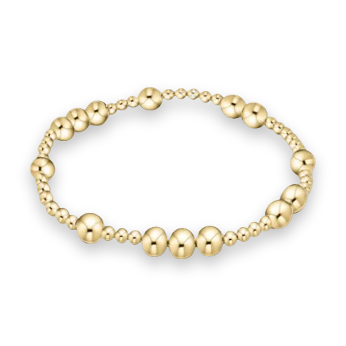 Gold jewelry beaded bracelet centered on a white background featuring polished spherical beads of varying sizes with high-shine reflective surfaces and an alternating pattern