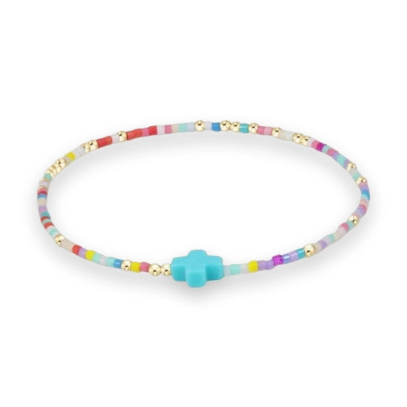 Beaded jewelry multi-colored strand bracelet displayed on a white background featuring a turquoise blue cross charm accented with metallic gold-tone spacer beads and a vibrant mix of pastel seed beads