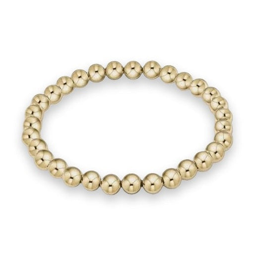 Gold-tone metal bead bracelet featuring a uniform strand of high-polish spherical beads with reflective metallic surfaces arranged in a seamless circle against a light grey background