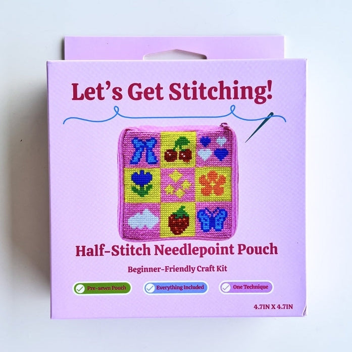 A pink retail box for a 'Let's Get Stitching! Half-Stitch Needlepoint Pouch' craft kit, photographed against a plain white background.